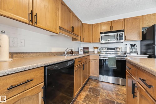 #6 12104 16 Av Sw, Edmonton, AB - Indoor Photo Showing Kitchen With Double Sink