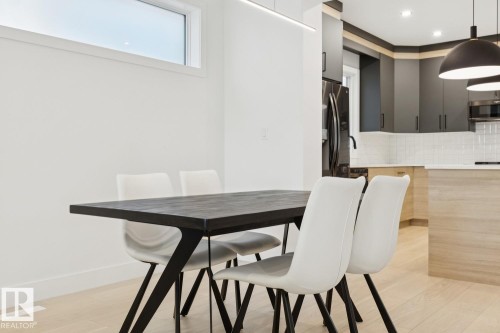 Open-concept dining area with light wood-finish flooring - 10531 67 Avenue Nw, Edmonton, AB - Indoor Photo Showing Dining Room