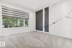 Room featuring a wide window with a dual-layer roller shade - 
