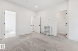 Spacious room with light-toned carpeting and bright white walls - 