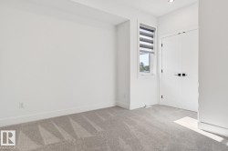 Neutral-toned carpet flooring complementing white walls and trim - 