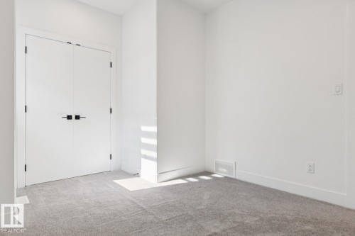 Interior room featuring a neutral color palette, light gray carpet, white baseboards, and white walls - 10531 67 Avenue Nw, Edmonton, AB - Indoor Photo Showing Other Room