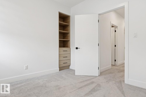 Built-in shelving unit with three drawers, light-toned wood-finish - 10531 67 Avenue Nw, Edmonton, AB - Indoor Photo Showing Other Room