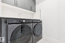 Contemporary laundry area featuring stacked appliances - 