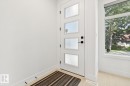 Contemporary entry door with frosted window panels and matte black hardware, accompanied by a large side window providing natural illumination - 10531 67 Avenue Nw, Edmonton, AB  - Indoor Photo Showing Other Room 