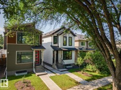 Contemporary exterior with multi-toned siding, a bold red entry door, and a covered porch - 