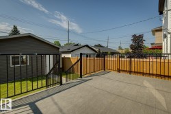 Spacious composite deck with dark metal railings - 