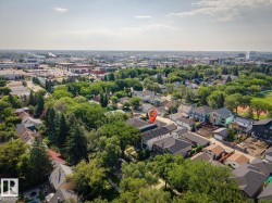 Aerial perspective showcasing a residential area with mature trees and established properties - 