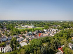 Aerial perspective showcasing a residential neighborhood with ample tree coverage - 