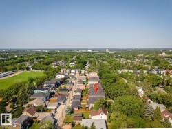 Aerial perspective showcasing a residential neighborhood with extensive tree coverage - 