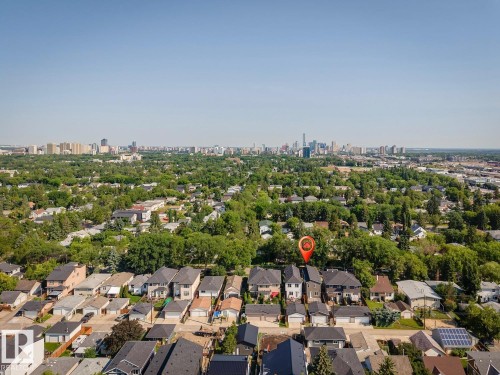 Aerial perspective of a residential neighborhood featuring detached homes with varied rooflines and a distant skyline - 10531 67 Avenue Nw, Edmonton, AB - Outdoor With View
