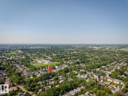 Extensive residential area with a prominent green space and distant urban skyline - 
