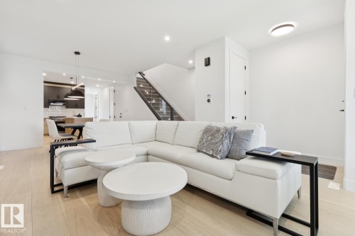 Open-concept living space featuring light wood-finish flooring, white walls, and recessed lighting - 10531 67 Avenue Nw, Edmonton, AB - Indoor Photo Showing Living Room