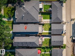 Aerial perspective showcasing multiple residential structures with dark shingle roofs - 