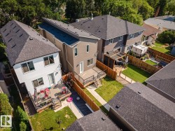 Aerial view showcasing multiple residential properties with pitched roofs, fencing, and private outdoor spaces - 