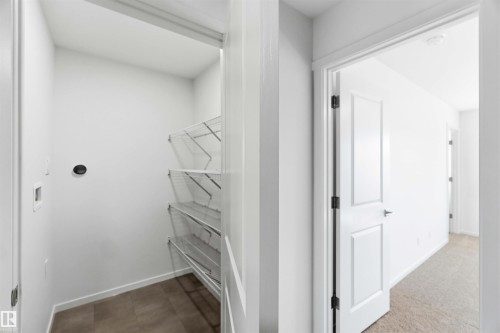 Dedicated utility closet featuring wire shelving and hookups - 223 157 Avenue Ne, Edmonton, AB - Indoor