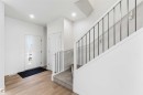 Foyer featuring light wood-finish flooring, a contemporary front door with an integrated vertical window, and recessed ceiling lighting - 223 157 Avenue Ne, Edmonton, AB  - Indoor Photo Showing Other Room 