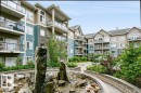 Multi-story residential building featuring balconies with glass railings, varied exterior siding, and stone accents - #137 10121 80 Av Nw, Edmonton, AB  - Outdoor With Facade 