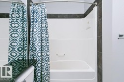White tub/shower combination with integrated grab bar - 