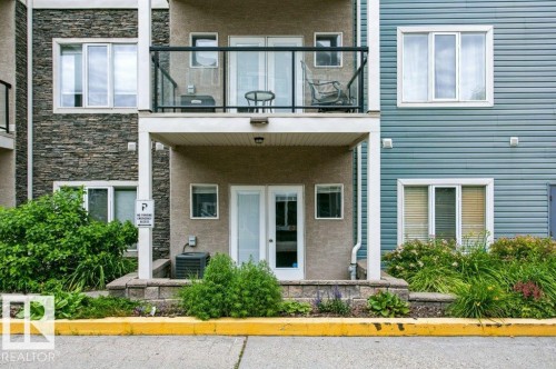 Exterior facade featuring a combination of stone veneer, stucco, and horizontal siding - #137 10121 80 Av Nw, Edmonton, AB - Outdoor