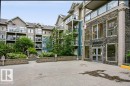 "Scona Gardens" building entrance featuring a stone facade and large window panels - #137 10121 80 Av Nw, Edmonton, AB  - Outdoor With Facade 