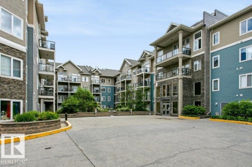 Multi-story residential buildings featuring stacked balconies with glass railings - #137 10121 80 Av Nw, Edmonton, AB - Outdoor With Facade