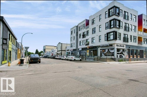 Modern commercial building featuring multiple levels, contemporary architecture, and ground-level retail spaces - #137 10121 80 Av Nw, Edmonton, AB - Outdoor