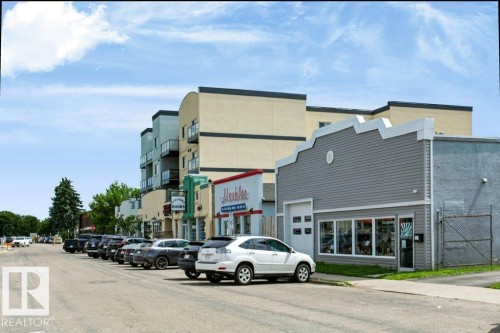 Commercial building with gray horizontal siding and a distinctive serrated parapet roofline - #137 10121 80 Av Nw, Edmonton, AB - Outdoor