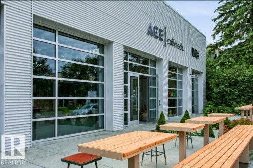 Modern commercial building featuring corrugated metal siding and extensive full-height glass frontage - #137 10121 80 Av Nw, Edmonton, AB - Outdoor With Exterior