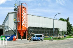 Industrial-style building with a prominent orange silo feature - 