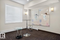 Bright window with white blinds, neutral wall paint, two wall-mounted sconces, and patterned carpet flooring - 