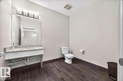 Bathroom featuring wood-look tile flooring and light gray wall paint - 