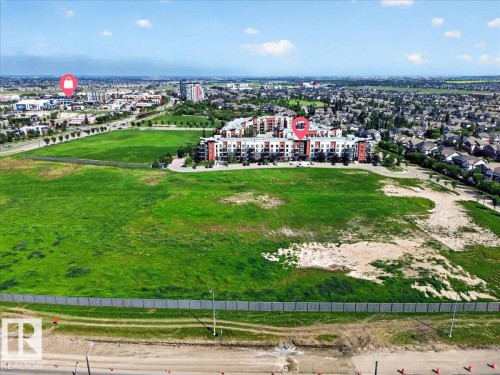 Expansive green space featuring large open areas - 106 320 Ambleside Link Sw, Edmonton, AB - Outdoor With View