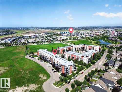 Aerial perspective showcasing a multi-building residential complex - 106 320 Ambleside Link Sw, Edmonton, AB - Outdoor With View