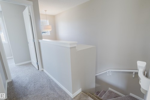 Upper level hallway featuring soft grey carpeting and light neutral wall paint - 17707 59 Street Nw, Edmonton, AB - Indoor