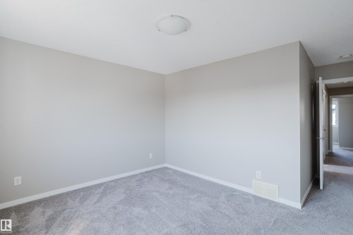Room featuring neutral wall paint, light gray carpeting, and white baseboards - 17707 59 Street Nw, Edmonton, AB - Indoor Photo Showing Other Room