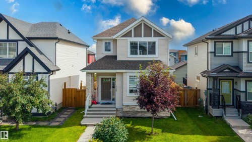 Contemporary two-story residence featuring light-colored siding with dark trim accents - 17707 59 Street Nw, Edmonton, AB - Outdoor With Facade