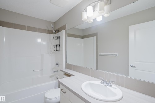 Bathroom featuring a white tub/shower combination with a single-handle faucet and showerhead - 17707 59 Street Nw, Edmonton, AB - Indoor Photo Showing Bathroom