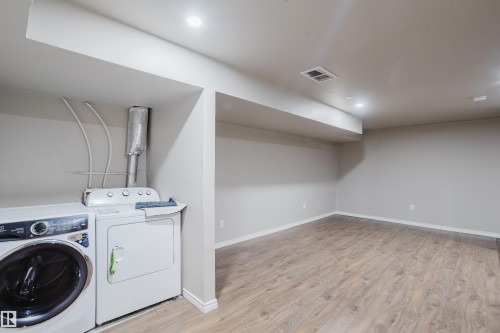 Interior space featuring wood-finish flooring, recessed lighting, and neutral wall paint - 17707 59 Street Nw, Edmonton, AB - Indoor Photo Showing Laundry Room