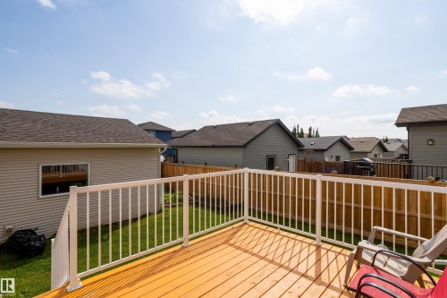 Expansive outdoor deck featuring wood-finish flooring and white railings - 17707 59 Street Nw, Edmonton, AB - Outdoor With Exterior