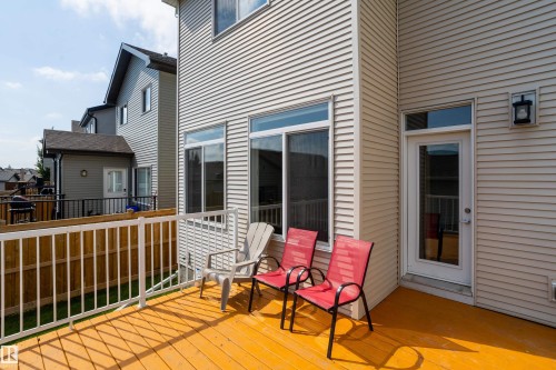 Elevated wooden deck featuring a white railing system, offering outdoor living space - 17707 59 Street Nw, Edmonton, AB - Outdoor With Deck Patio Veranda With Exterior