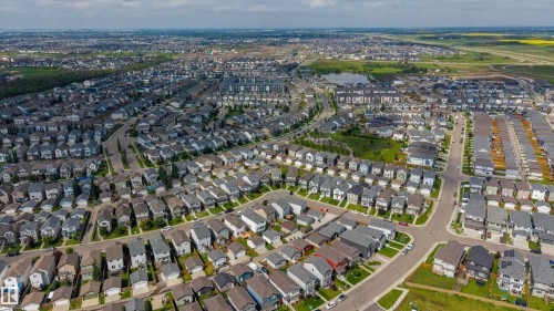 Expansive aerial perspective showcasing a modern residential development with varied architectural styles - 17707 59 Street Nw, Edmonton, AB - Outdoor With View