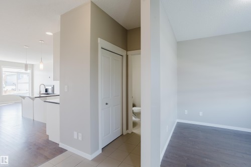 Entryway with tile flooring opening to a kitchen and a separate room - 17707 59 Street Nw, Edmonton, AB - Indoor Photo Showing Other Room