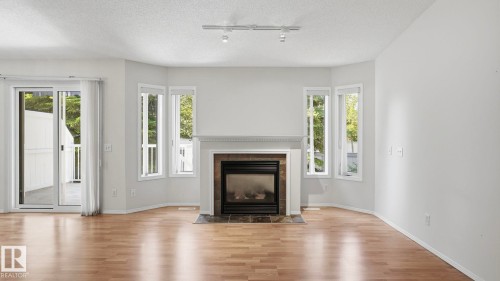 #31 8 Dechene Rd Nw, Edmonton, AB - Indoor Photo Showing Living Room With Fireplace