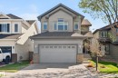 Contemporary two-story residence featuring a gray siding exterior and an attached garage with a concrete driveway - 9 Snowbird Crescent, Leduc, AB  - Outdoor With Facade 