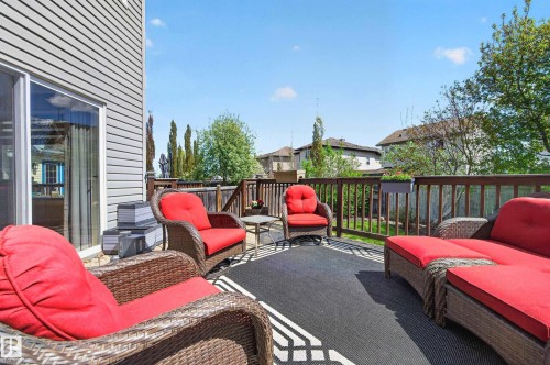 Spacious elevated deck featuring wood railings and a dark outdoor area rug - 9 Snowbird Crescent, Leduc, AB - Outdoor With Deck Patio Veranda With Exterior