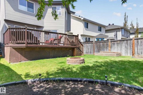 Wood deck featuring dark railings, lattice skirting, and direct yard access - 9 Snowbird Crescent, Leduc, AB - Outdoor With Deck Patio Veranda With Exterior