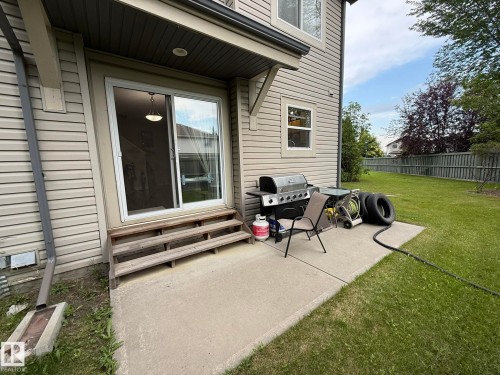 Rear concrete patio with direct access to a sliding glass door - #93 12050 17 Av Sw, Edmonton, AB - Outdoor With Deck Patio Veranda With Exterior