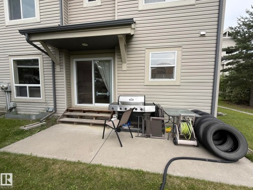 Rear concrete patio with direct backyard access - #93 12050 17 Av Sw, Edmonton, AB - Outdoor With Deck Patio Veranda With Exterior