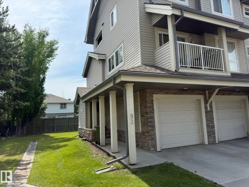 Exterior featuring light-toned siding and a partial stone facade - #93 12050 17 Av Sw, Edmonton, AB - Outdoor